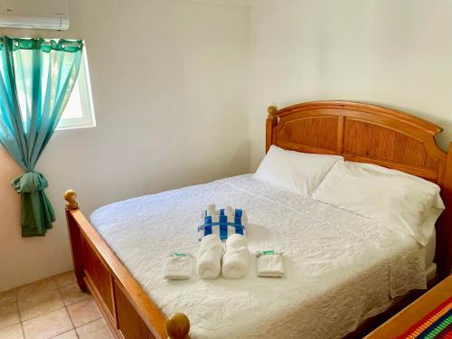 a bedroom with a bed with two towels on it at Seaside Villas in Caye Caulker