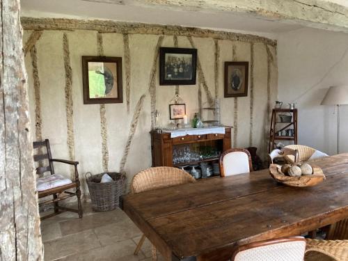 a dining room with a wooden table and chairs at Maison de vacances Gers in Manciet