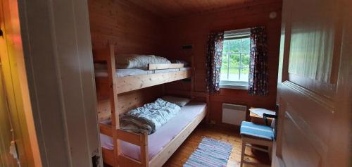a room with two bunk beds in a house at Midtgard in Tyinkrysset