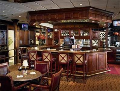 a bar in a restaurant with tables and chairs at Molly Pitcher Inn in Red Bank