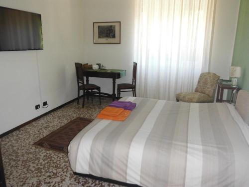 a hotel room with a bed and a table and chairs at Green Quercia Apartment in Como
