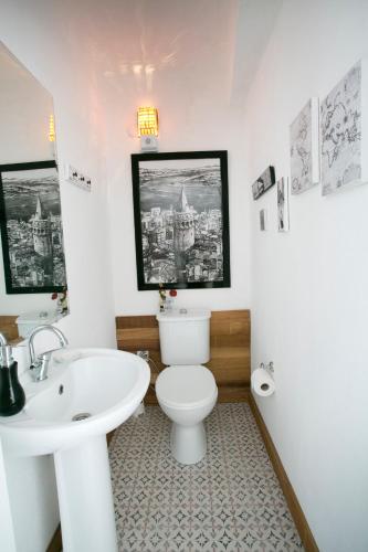 a bathroom with a white toilet and a sink at Morlimon in Alaçatı