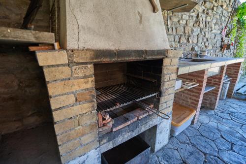 an old brick oven with its door open at Garai Etxea, casa adosada en la montaña in Arrankudiaga