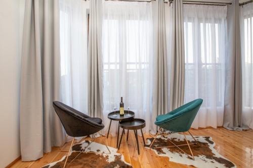 a room with two chairs and a table and a window at NORTH STORY - Luxury Chalet - Apartments & rooms in Žabljak