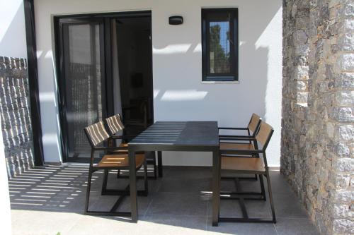 a black table and chairs on a patio at Chill and Thrill Apartments in Mastichari
