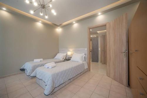 1 dormitorio con 2 camas y un espejo grande en El Sueño de Zante 2nd City Center Apartments en Zakynthos