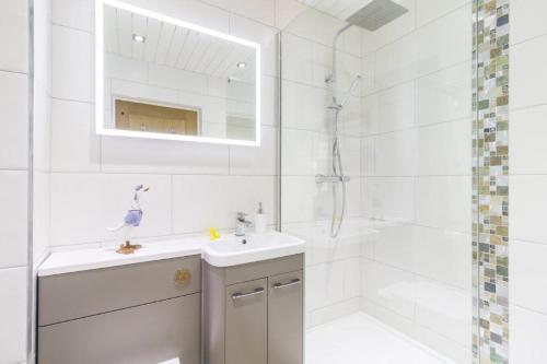 a white bathroom with a sink and a shower at Minster View Apartment at Talbot Court, York in York