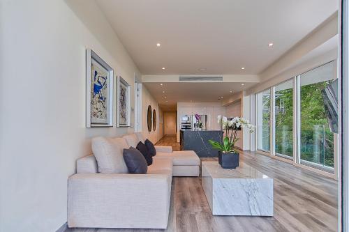 a living room with a couch and a table at Maxwell Residences at Indah in Puerto Vallarta