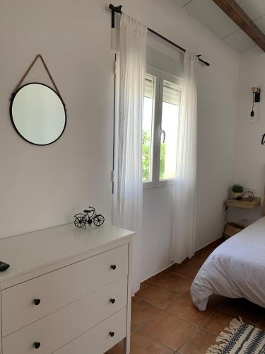 a bedroom with a dresser with a mirror on it at ALAMANCHA in Casas de los Pinos