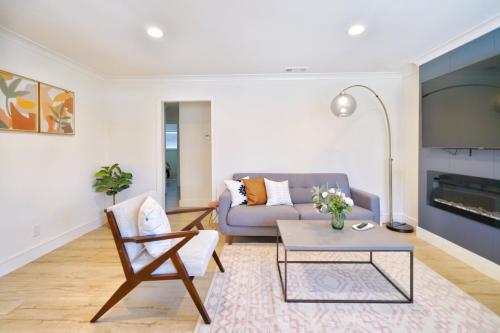 a living room with a couch and a table at @ Marbella Lane - Vibrant 4BR RWC Ldry + P in Redwood City