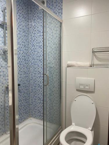 a bathroom with a toilet and a glass shower at Apartment Vesna City PG in Podgorica