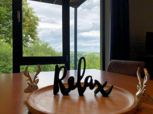 a wooden table with a sign that says ruby in front of a window at Enjoy Durbuy 4 in Durbuy