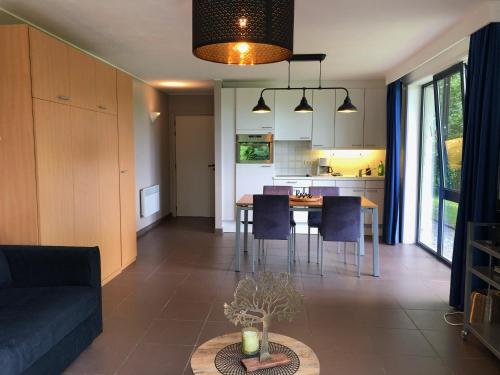 a living room and kitchen with a table and chairs at Enjoy Durbuy 4 in Durbuy