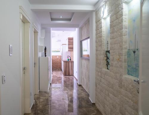 a hallway of a house with a refrigerator at Golden Apartments in Ulcinj