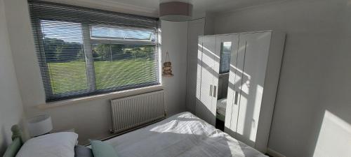 a bedroom with a bed and a window at Rosa Blanca in Sandown