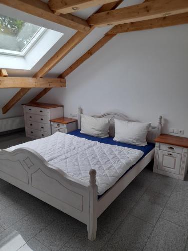 Haus Lehenthaler في Stadtsteinach: غرفة نوم بسرير في غرفة بسقوف خشبية
