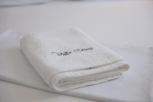 a pile of white towels sitting on a table at APARTMANI OLIMP in Sveti Juraj