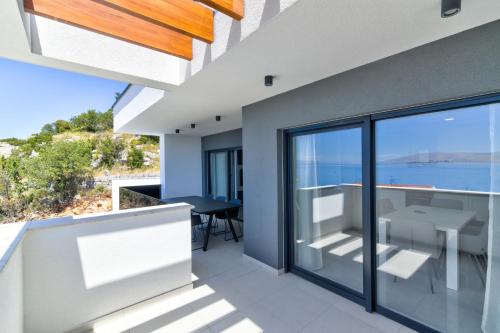 a house with a view of the ocean at APARTMANI OLIMP in Sveti Juraj