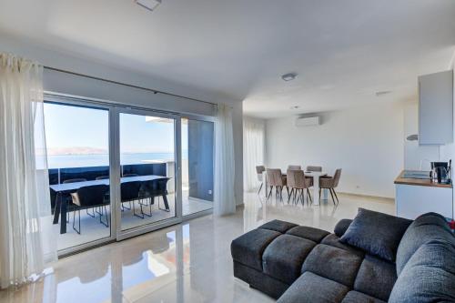 a living room with a couch and a dining room at APARTMANI OLIMP in Sveti Juraj