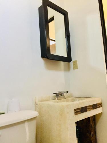 a bathroom with a sink and a mirror on the wall at Tu casa con pérgola en La Paz BCS in La Paz