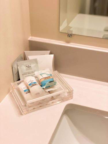 two containers of toothpaste sitting on a counter in a bathroom at Silverwood Motel in Cavendish