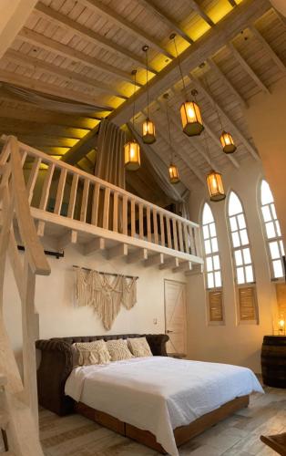 a bedroom with a large bed with a loft at Casa Martha hotel boutique in Tequisquiapan