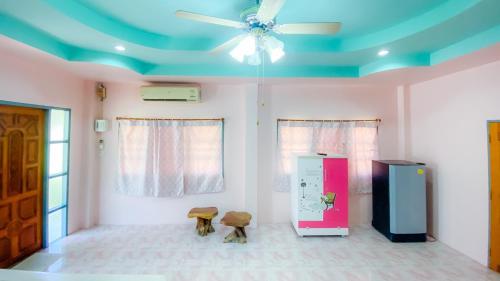 a room with a blue ceiling and a refrigerator at BaanChomJan @ Suanphung in Suan Phung