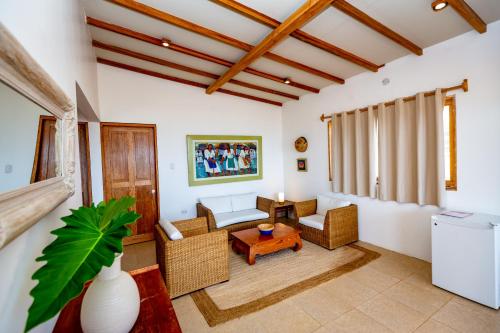 a living room with a couch and a table at Hotel Punta Camarón Bungalows & Suites in Zorritos