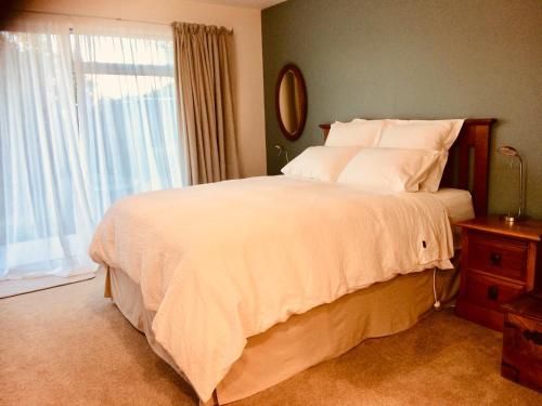 a bedroom with a large bed and a window at Art Glass Studio in Wanaka