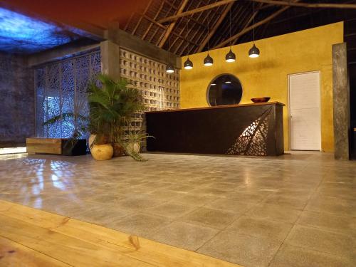 a dance floor with a table and a potted plant at Casa Beach Hotel "Casa Del Mar" in Jambiani