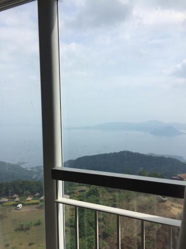 a view from a window of a mountain at Wind and Sea at Wind Residences in Tagaytay