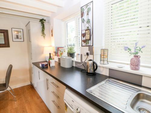 a kitchen with a sink and a counter top at Lavender Cottage in Ripon