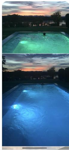 a large swimming pool with blue lights on it at Chiang Khan Riverside Pool Villa in Chiang Khan