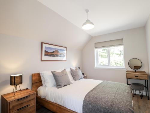 a bedroom with a bed and a window at The Loft in Spean Bridge