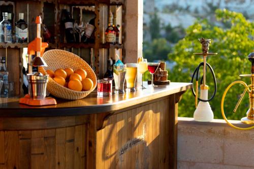 a counter with a bowl of oranges and drinks on it at Lord of Cappadocia Hotel in Goreme