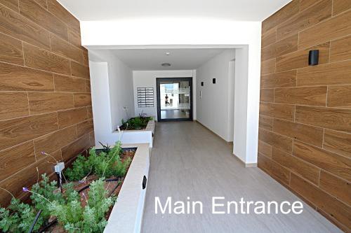 a hallway of a main entrance of a building at Golden Tree Apartment in Paralimni