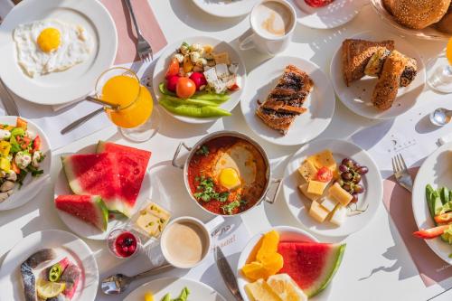 a table filled with plates of food and drinks at Enjoy Dead Sea Hotel in Ein Bokek