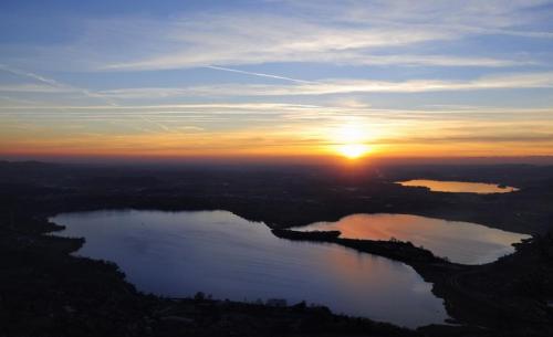 an aerial view of a lake at sunset at Big family bed & breakfast in Suello