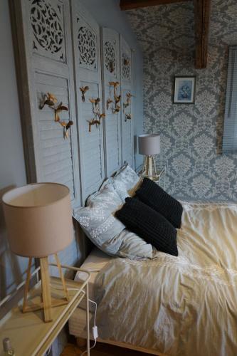 a bedroom with a bed with two pillows on it at La Marlière Chambre de Charme in Houthem