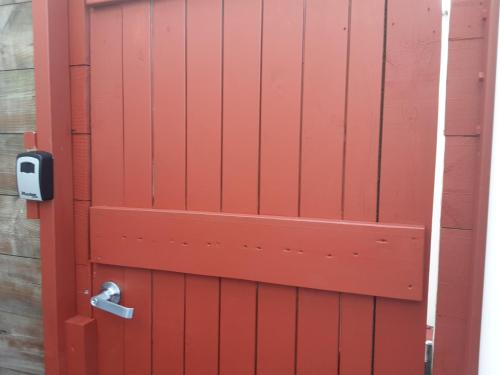 a red door with a lock on it at I'm a traveller in Dunedin