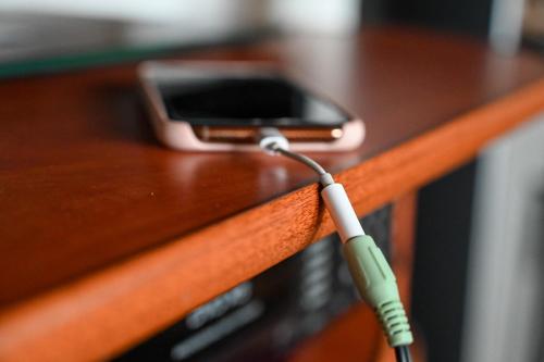 a cell phone hooked up to a charger on a table at Chalupa pod Ještědem in Světlá pod Ještědem