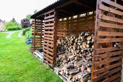 a pile of fire wood in a wooden structure at Chalupa pod Ještědem in Světlá pod Ještědem