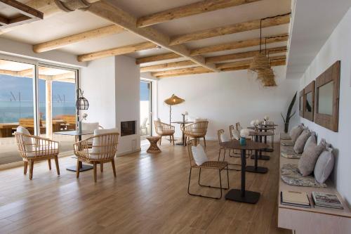 a living room filled with furniture and a patio at May Altafulla Beach Boutique Hotel in Altafulla