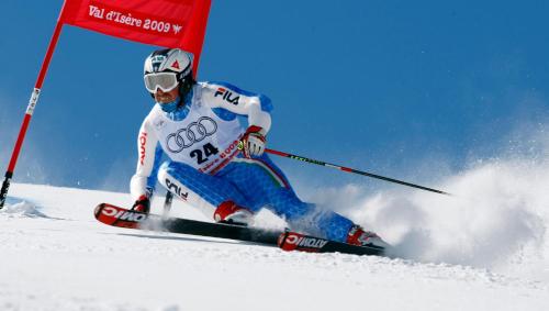 a man is skiing down a snow covered slope at B&B Ciasa Brüscia in San Vigilio Di Marebbe