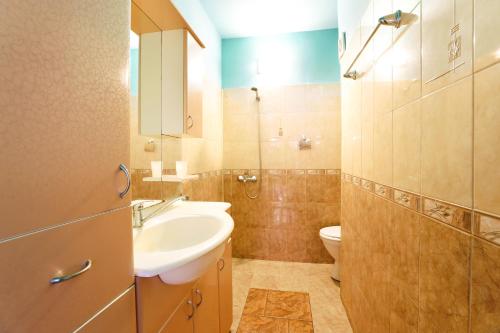 a bathroom with a sink and a toilet at La Piazza Family Hotel in Sunny Beach