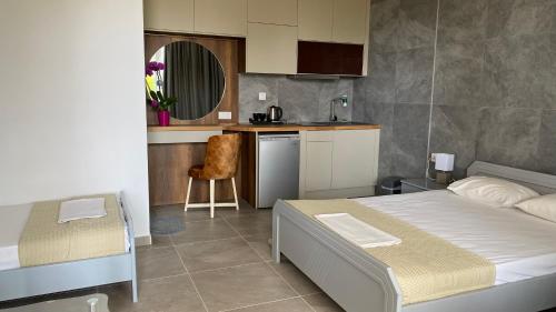 a bedroom with a bed and a small kitchen at Oasis in Paralia Katerinis