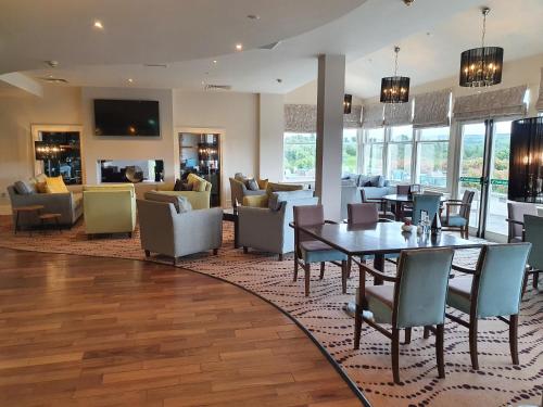 a living room with a table and chairs at Westport Country Lodge Hotel in Westport