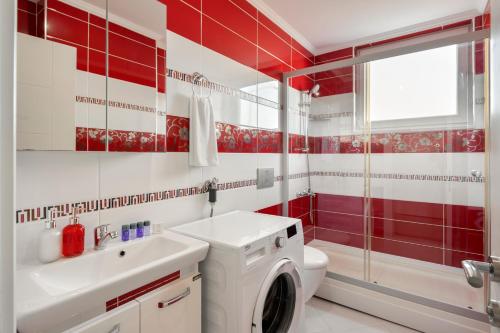 a red and white bathroom with a toilet and a sink at Onix Apart Hotel in Antalya