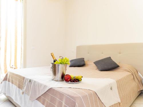 a table with a bowl of fruit on a bed at Arco del Mare - swimming pool with nice sea view in Civezza
