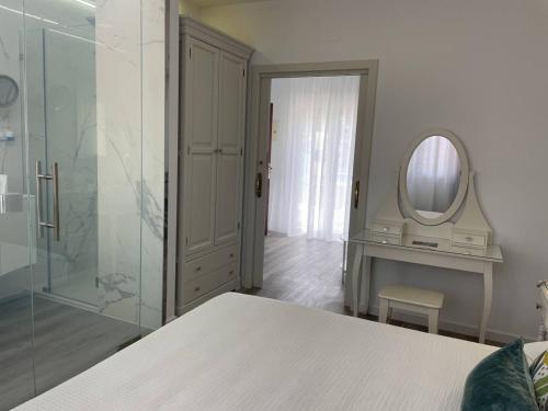a white bathroom with a mirror and a dressing table at Hotel Malaga Picasso in Málaga